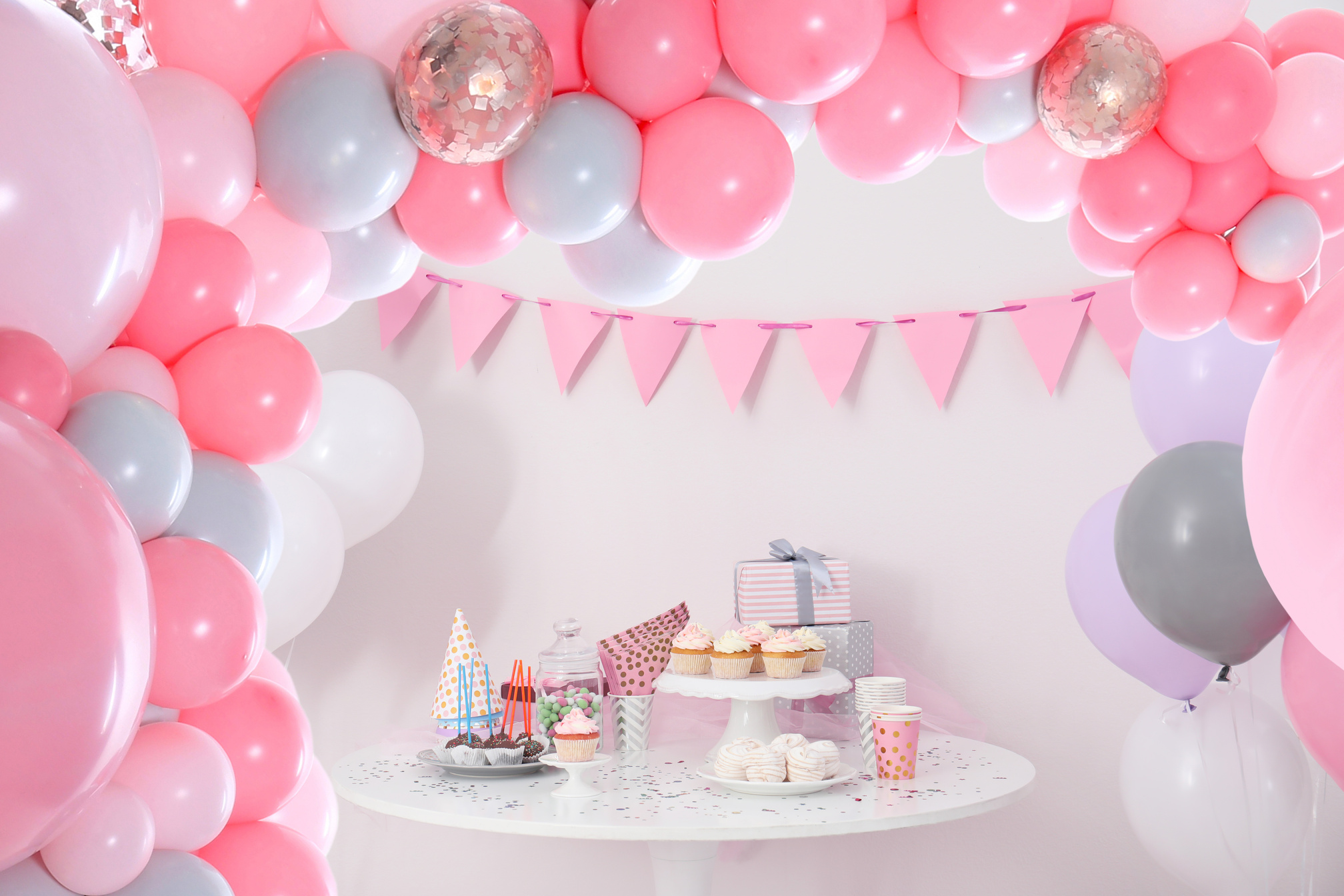 Party Treats and Items on Table in Room Decorated with Balloons